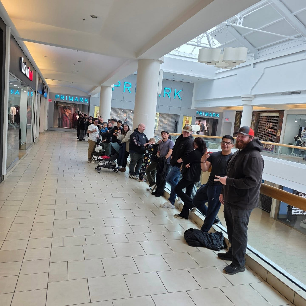 A Pokémon release day line stretching down the mall corridor at Cards2Go Freehold Raceway Mall in Freehold, NJ